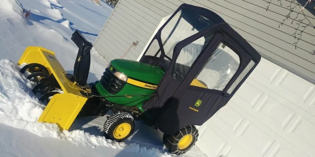 Garden tractor with outlet snowblower